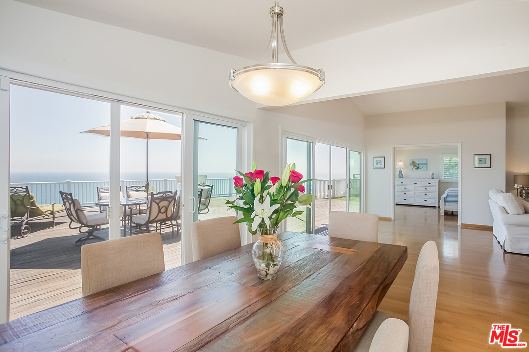 18440 Coastline Drive Malibu, CA 90265 - Photo 6 of 21 a living room with furniture potted plant and a large window