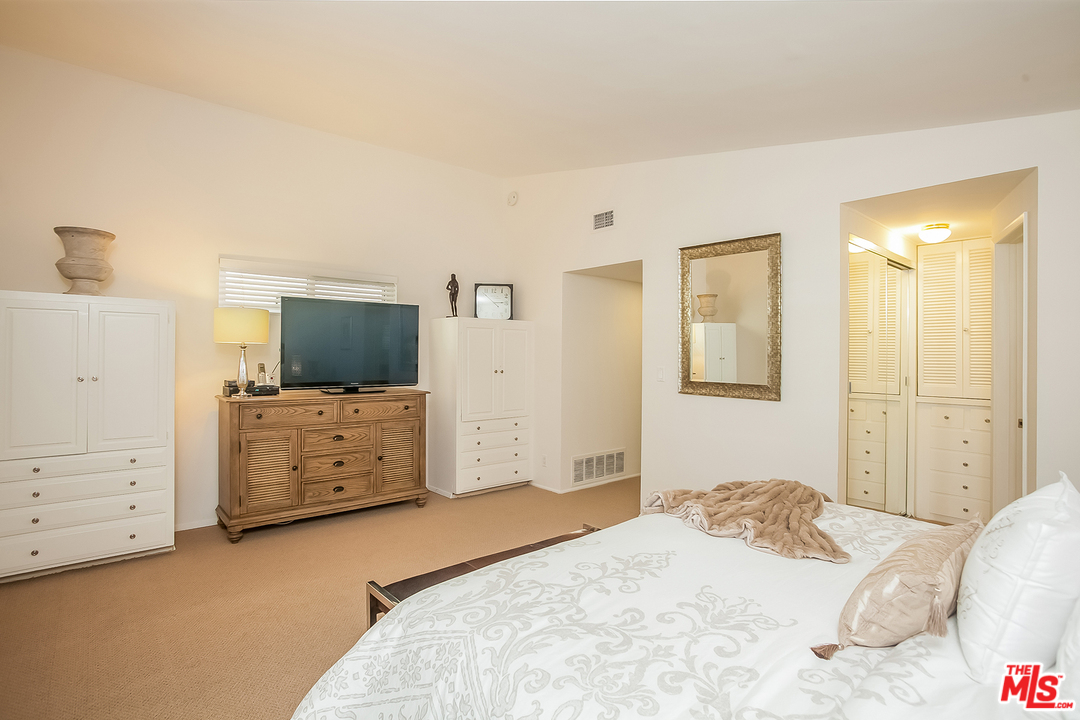18440 Coastline Drive Malibu, CA 90265 - Photo 10 of 21 a bedroom with a bed and flat screen tv