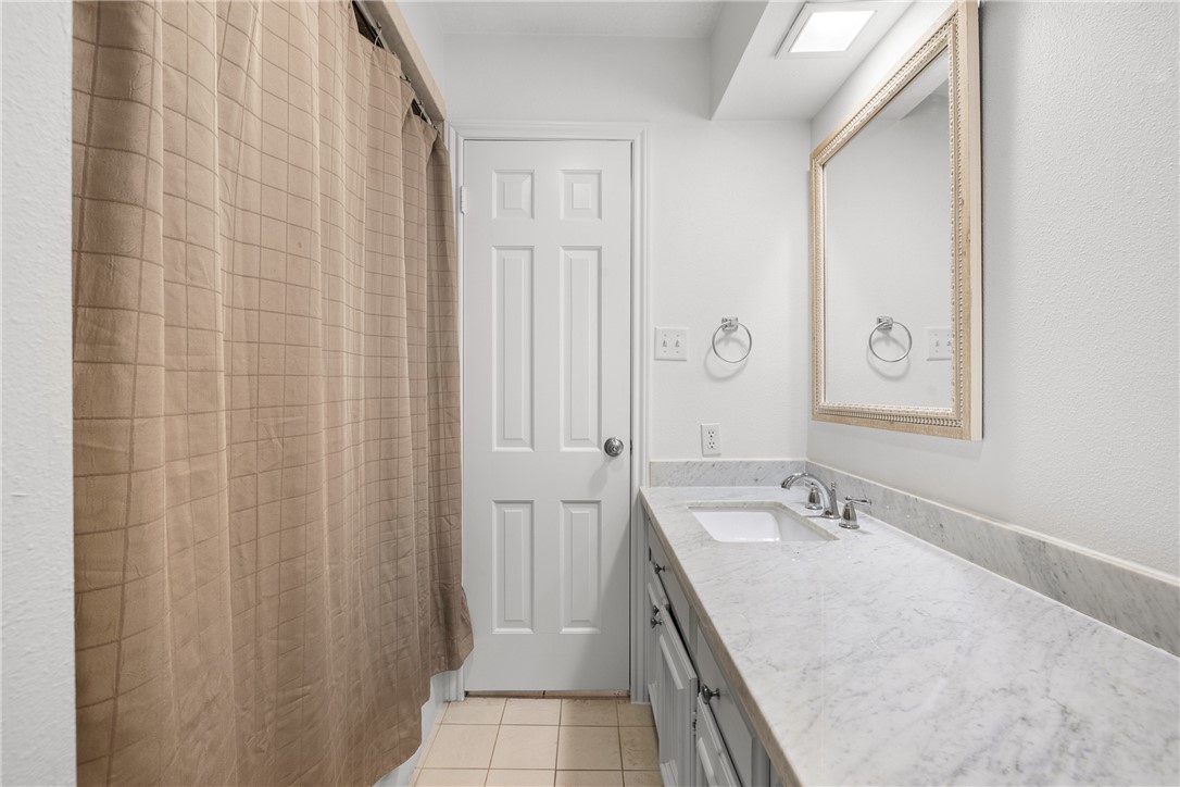 871 Cazey Loop Franklin, TX 77856 - Photo 28 of 42 a bathroom with a granite countertop sink and a mirror