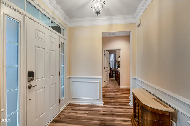 a view of a hallway with wooden floor and staircase