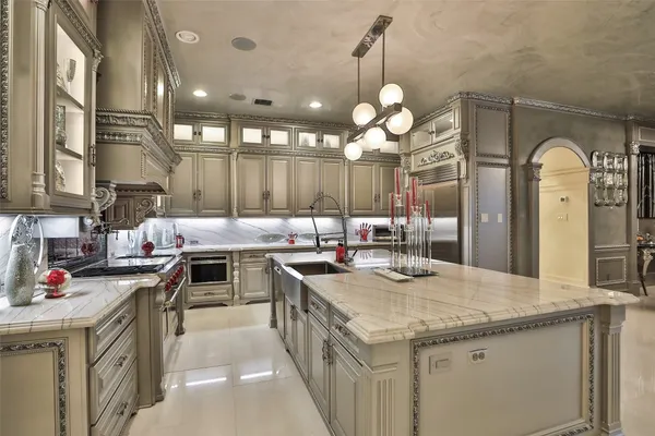 a kitchen with a stove kitchen island and living room