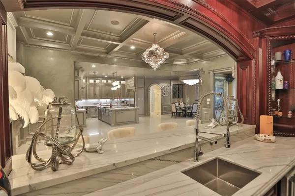 a lobby with furniture and chandelier