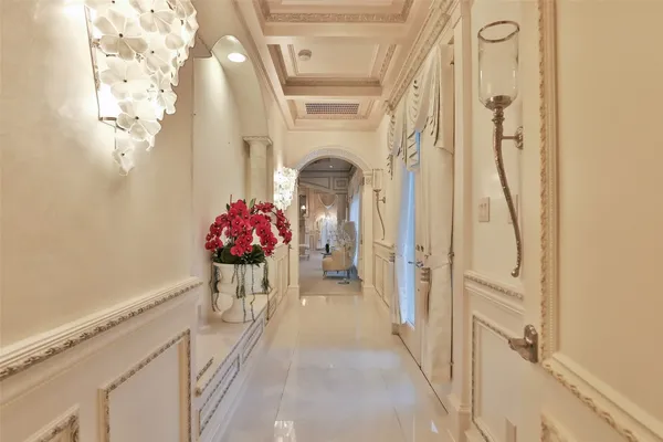 a spacious bedroom with bed and a chandelier