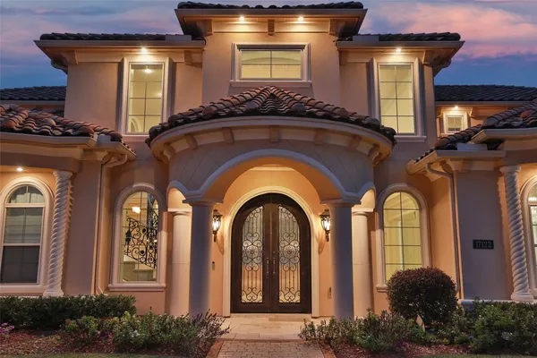 a front view of a house with large windows