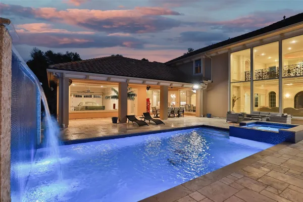 a living room with furniture fireplace and floor to ceiling windows