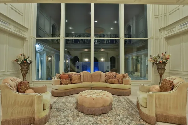 a living room with furniture and a floor to ceiling window