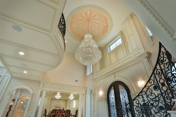 a view of a dining room with furniture and a chandelier