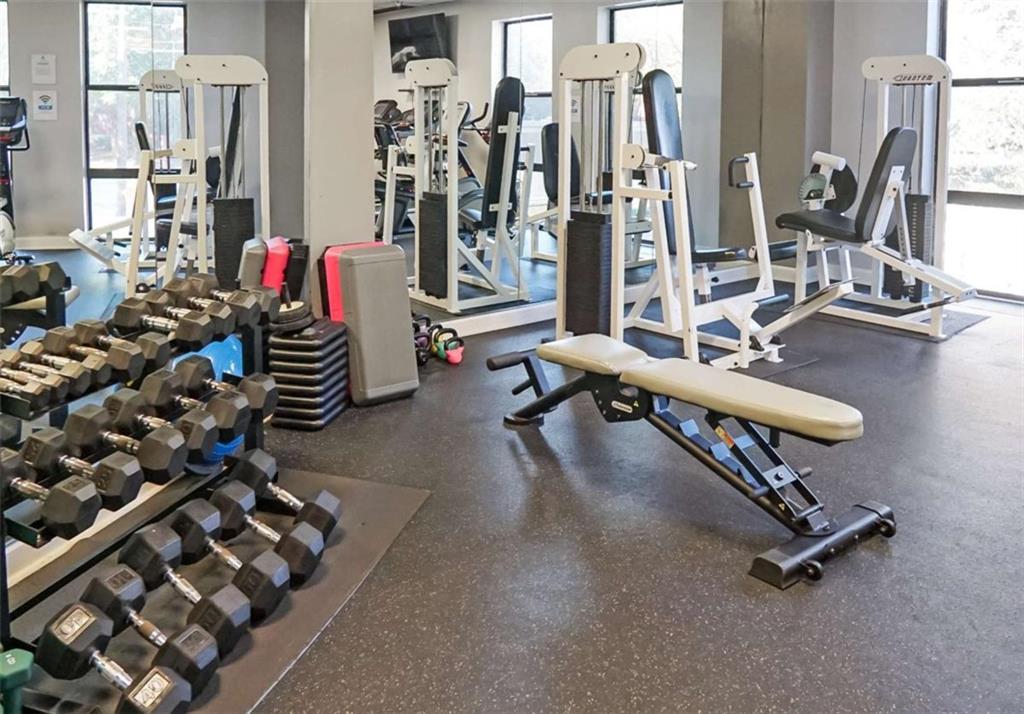 375 Ralph McGill Boulevard Northeast, Unit 108 Atlanta, GA 30312 - Photo 12 of 13 a room with gym equipment and a view of living room