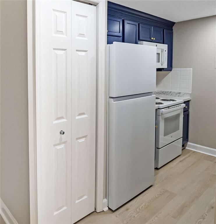 375 Ralph McGill Boulevard Northeast, Unit 108 Atlanta, GA 30312 - Photo 5 of 13 a white refrigerator freezer and a stove sitting inside of a kitchen