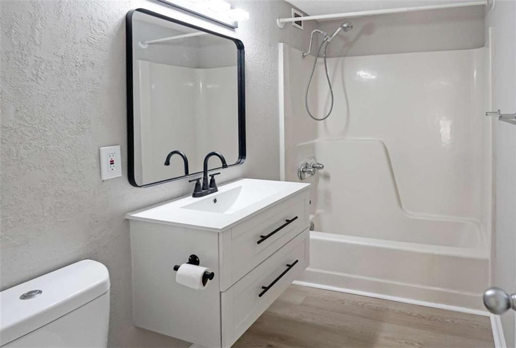 375 Ralph McGill Boulevard Northeast, Unit 108 Atlanta, GA 30312 - Photo 7 of 13 a bathroom with a sink a toilet and shower