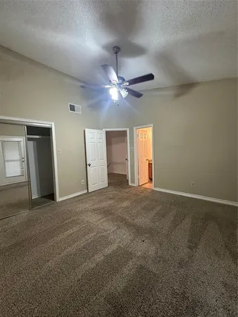 a view of a livingroom with a ceiling fan and window