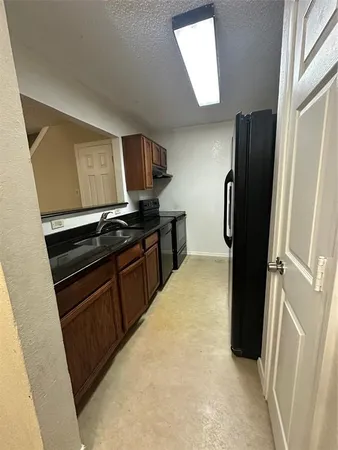 a kitchen with a refrigerator stove and sink