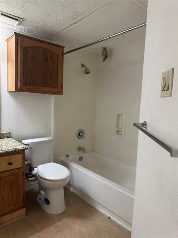 a bathroom with a toilet and a bathtub