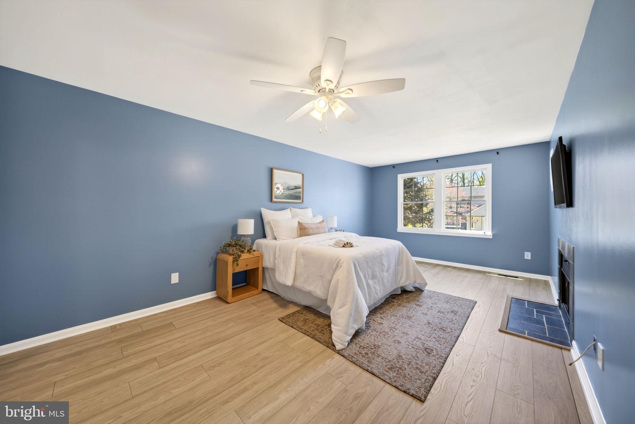 9331 Oak White Road Nottingham, MD 21236 - Photo 17 of 34 a bedroom with a large bed and a chandelier