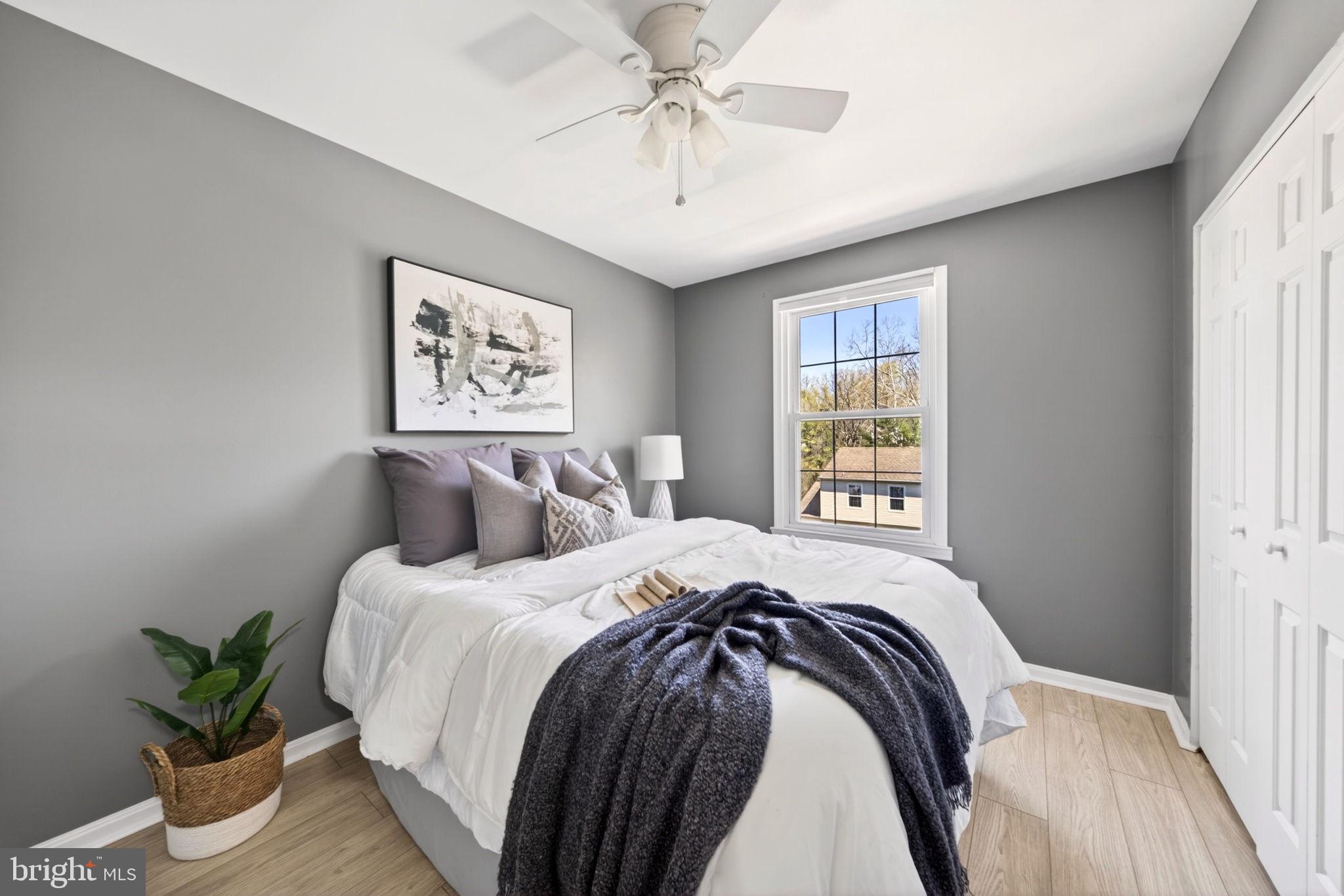 9331 Oak White Road Nottingham, MD 21236 - Photo 23 of 34 a bedroom with a large bed and a chandelier