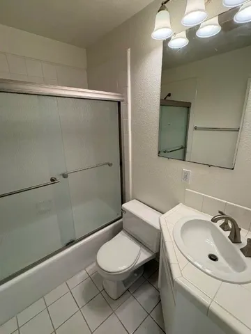 a bathroom with a toilet sink and shower