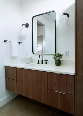 a bathroom with a double vanity sink and mirror