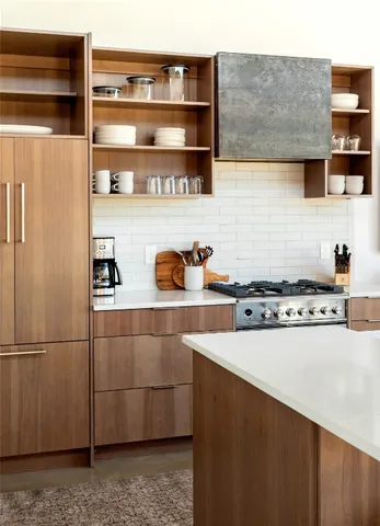 a kitchen with stainless steel appliances a refrigerator and a stove