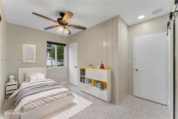 a view of a livingroom with a ceiling fan and window