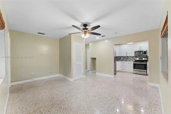 a kitchen with stainless steel appliances granite countertop a refrigerator and a stove top oven