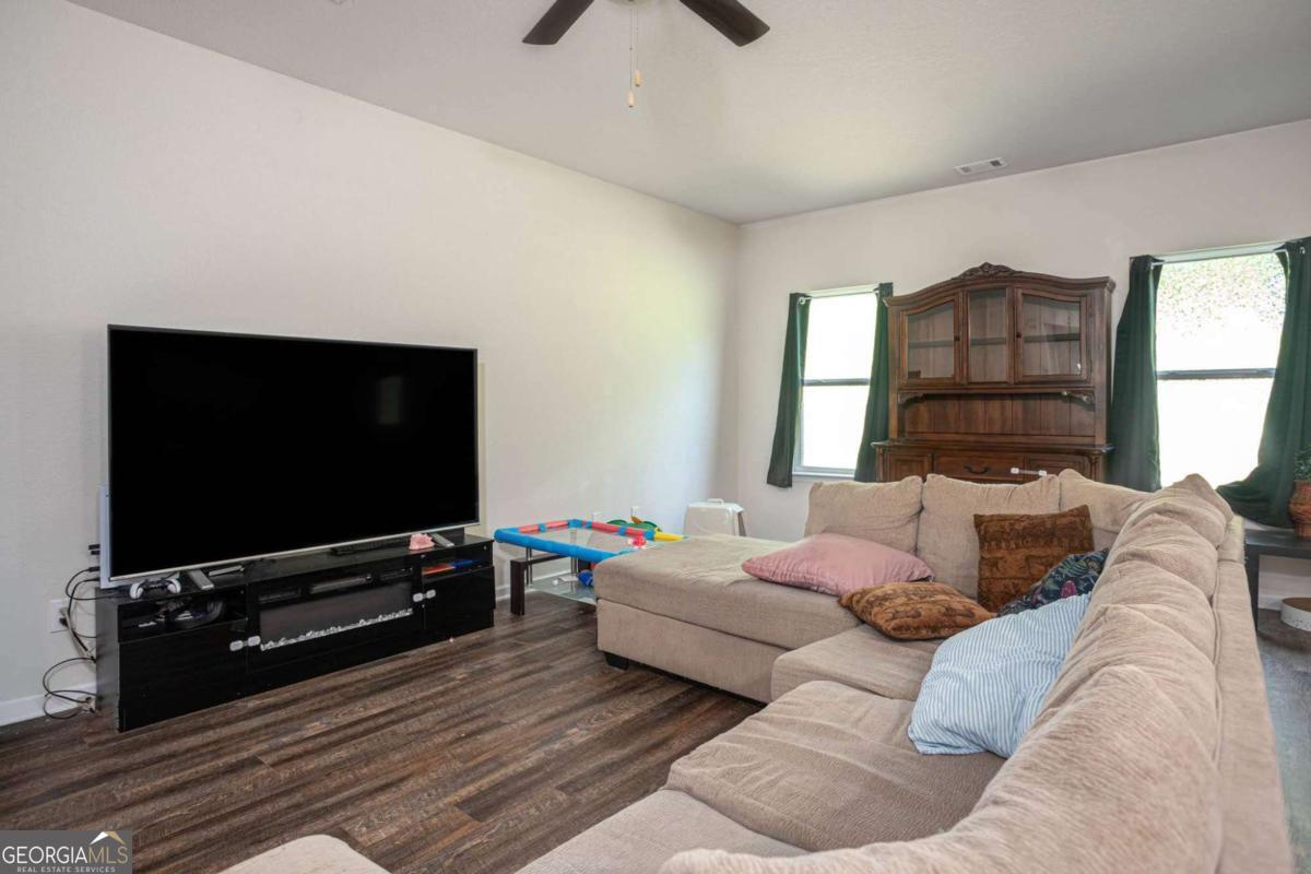 653 Meadows Farm Way Monroe, GA 30655 - Photo 8 of 34 a living room with furniture and a flat screen tv