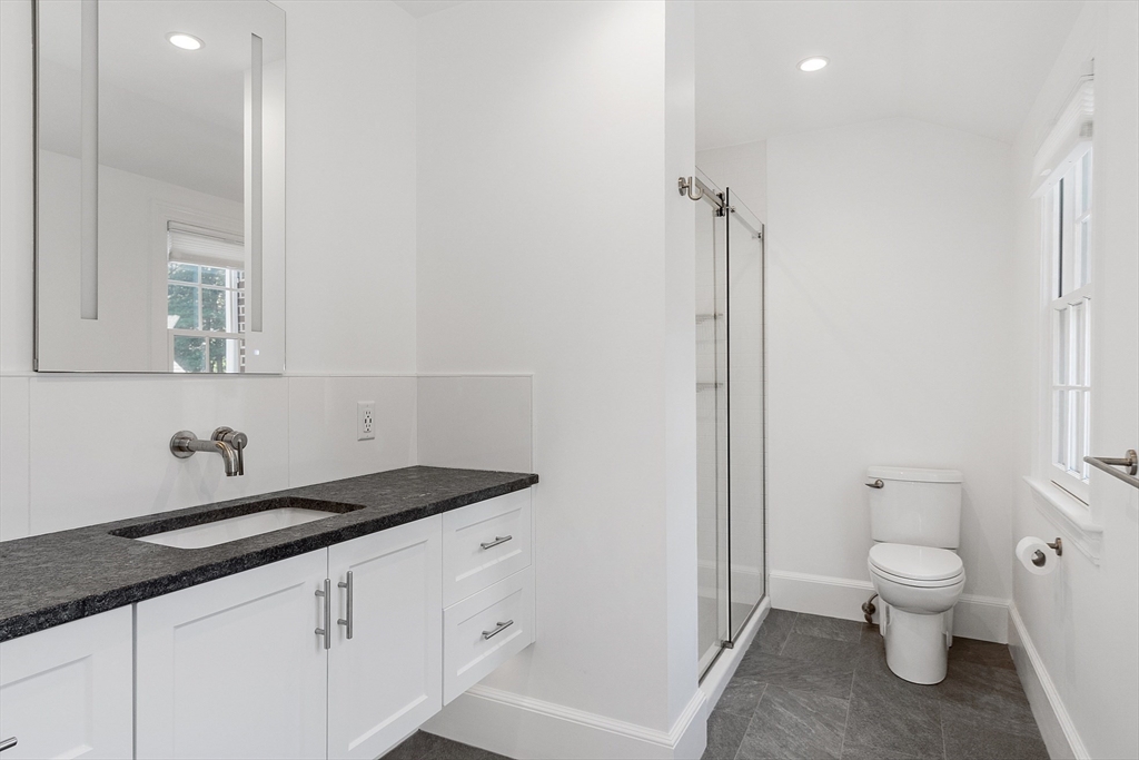 40 Grandview Road Chelmsford, MA 01824 - Photo 33 of 42 a bathroom with a granite countertop sink a toilet and a mirror