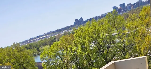 a view of an empty room with large windows
