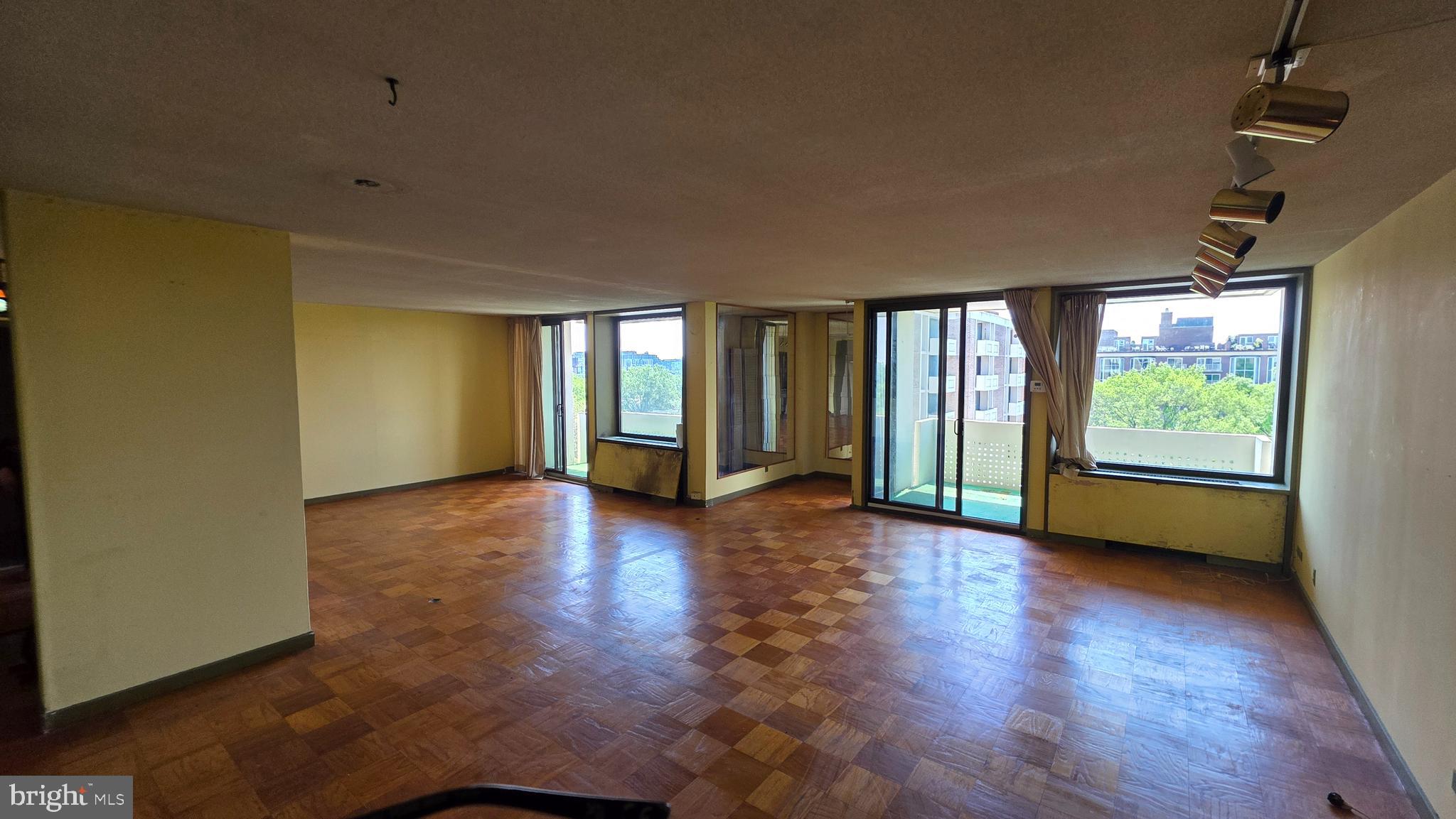 490 M Street Southwest, Unit W705 & 709 Washington, DC 20024 - Photo 26 of 37 an empty room with wooden floor and windows