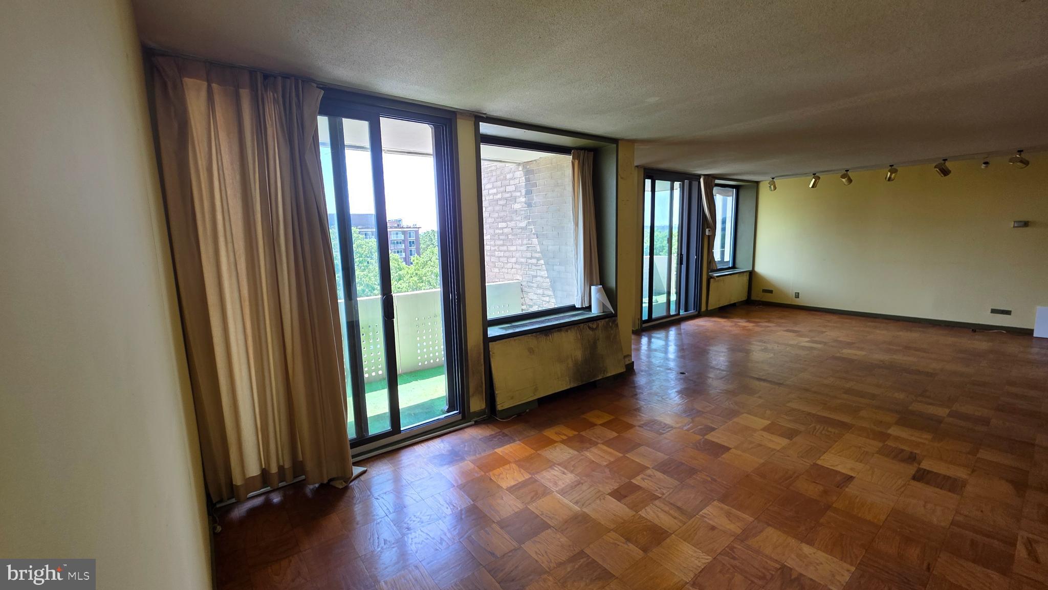 490 M Street Southwest, Unit W705 & 709 Washington, DC 20024 - Photo 27 of 37 an empty room with wooden floor and windows