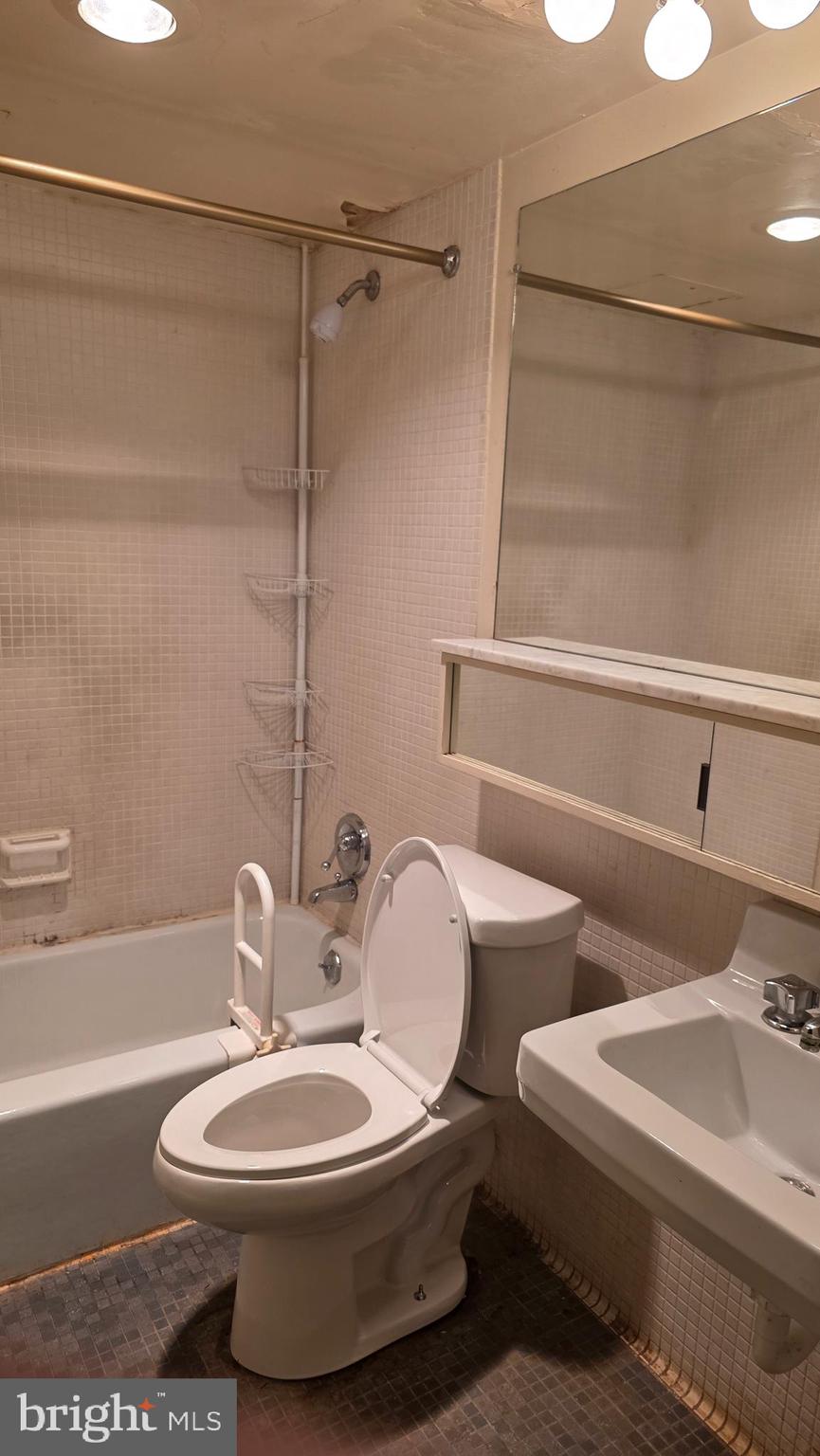 490 M Street Southwest, Unit W705 & 709 Washington, DC 20024 - Photo 31 of 37 a bathroom with a toilet sink and mirror