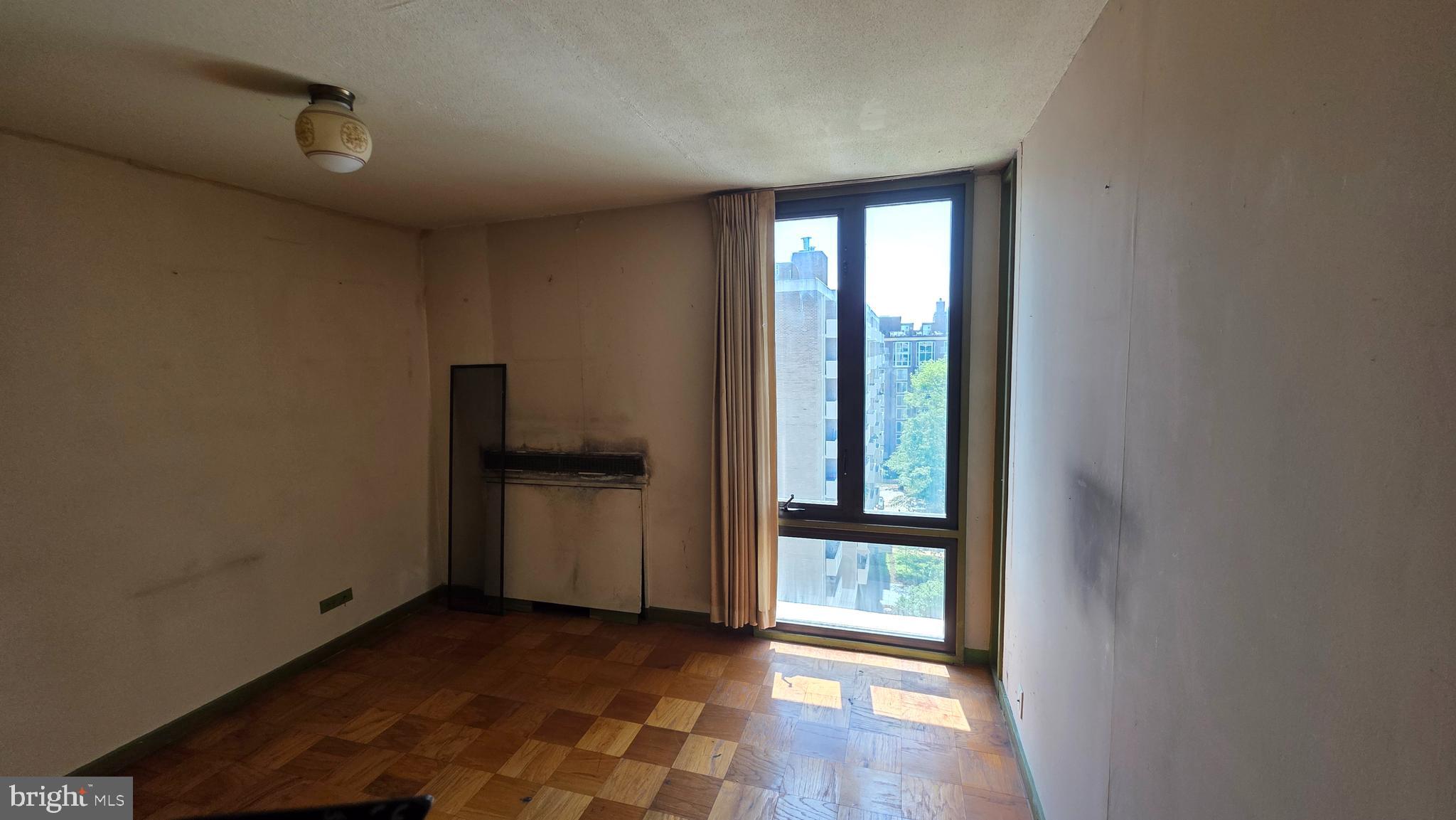 490 M Street Southwest, Unit W705 & 709 Washington, DC 20024 - Photo 32 of 37 a view of an empty room with wooden floor and a window