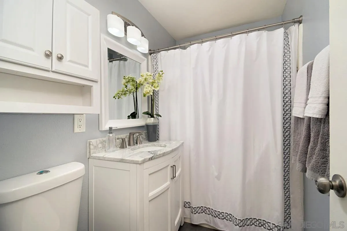 14112 Frame Road Poway, CA 92064 - Photo 24 of 30 a bathroom with a sink a toilet and a mirror