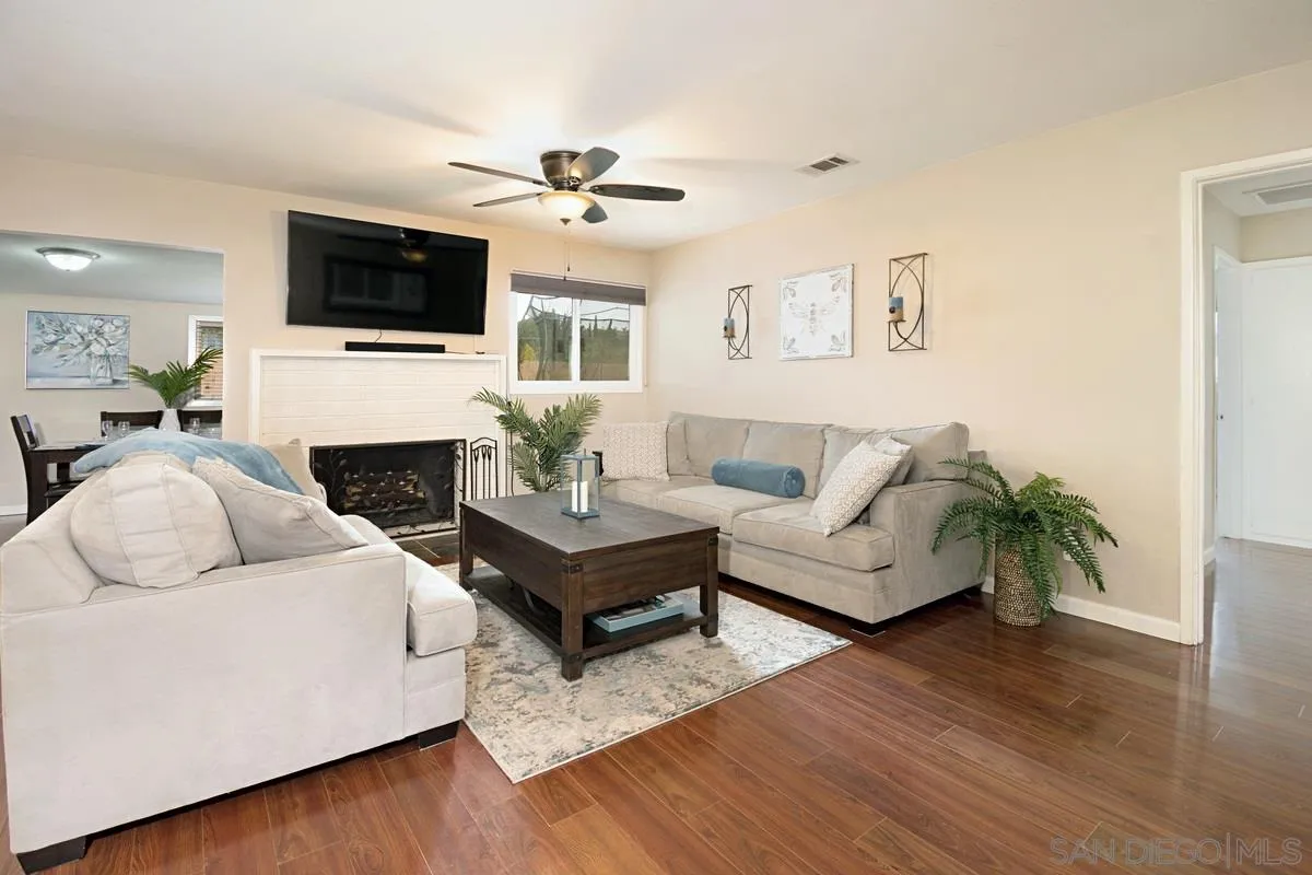 14112 Frame Road Poway, CA 92064 - Photo 3 of 30 a living room with furniture a fireplace and a flat screen tv