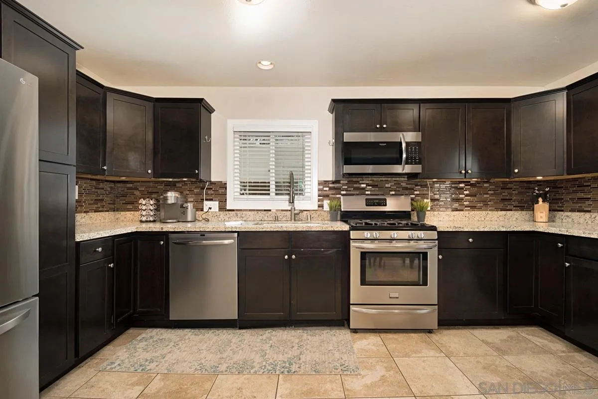 14112 Frame Road Poway, CA 92064 - Photo 7 of 30 a kitchen with a stove top oven sink and cabinets