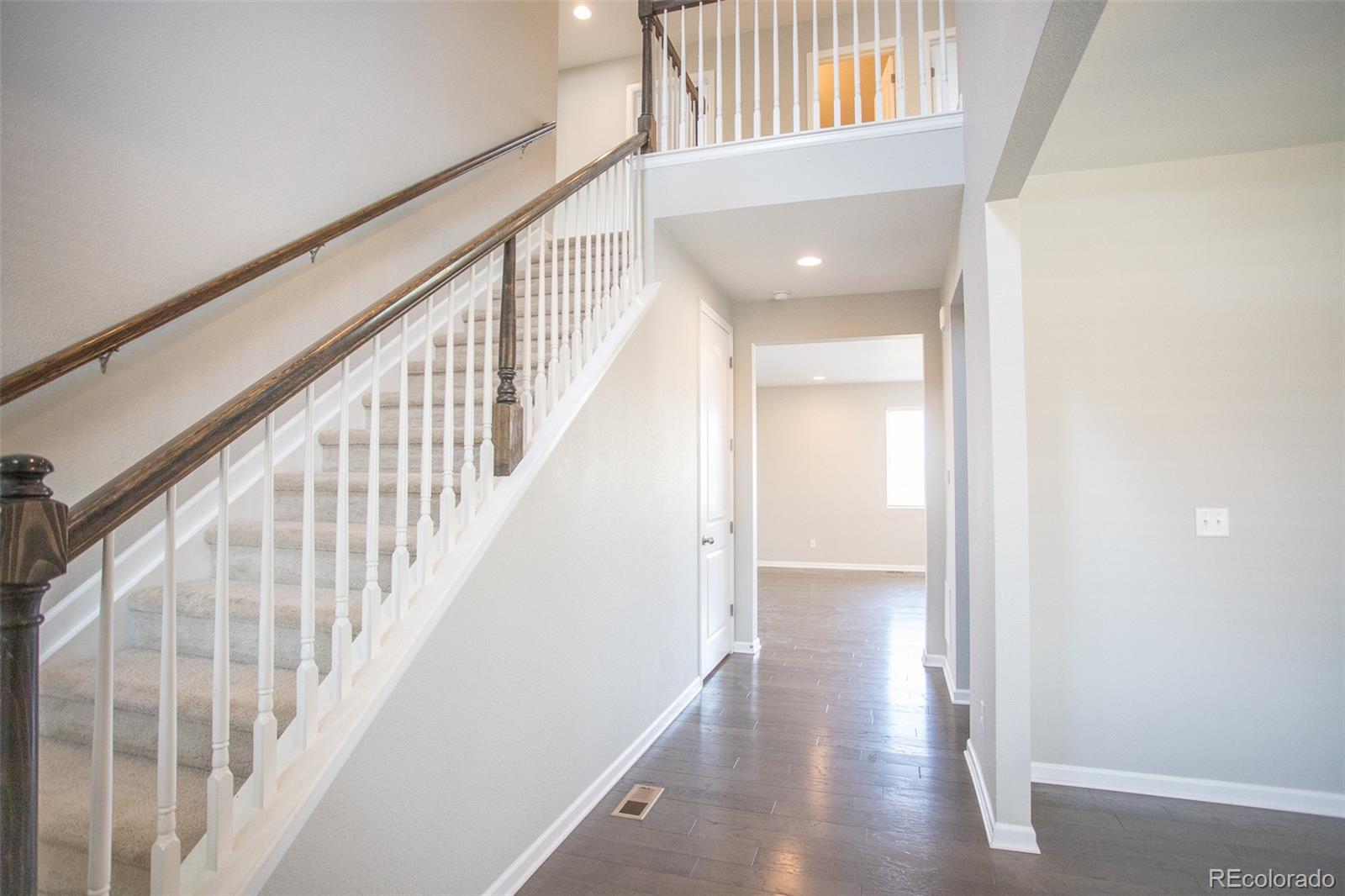 16343 East 100th Way Commerce City, CO 80022 - Photo 16 of 38 a view of an entryway with wooden floor