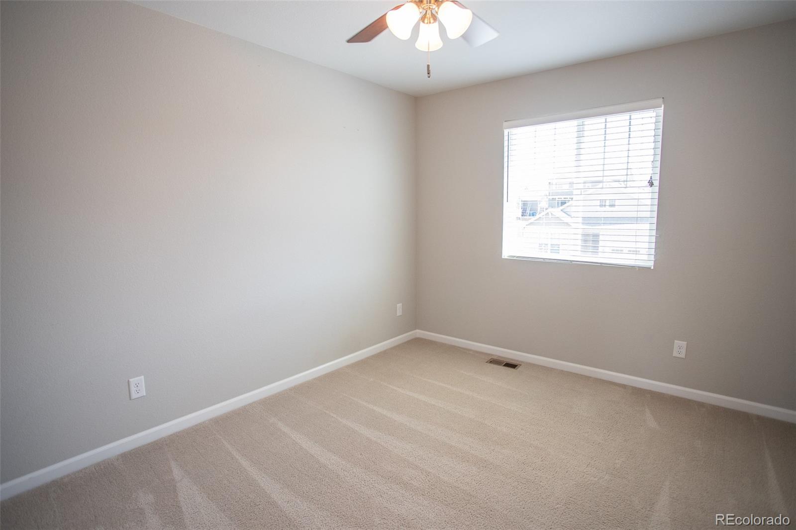 16343 East 100th Way Commerce City, CO 80022 - Photo 18 of 38 an empty room with a window