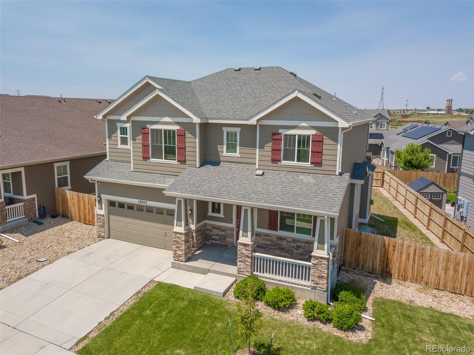 16343 East 100th Way Commerce City, CO 80022 - Photo 2 of 38 a front view of a house with a yard