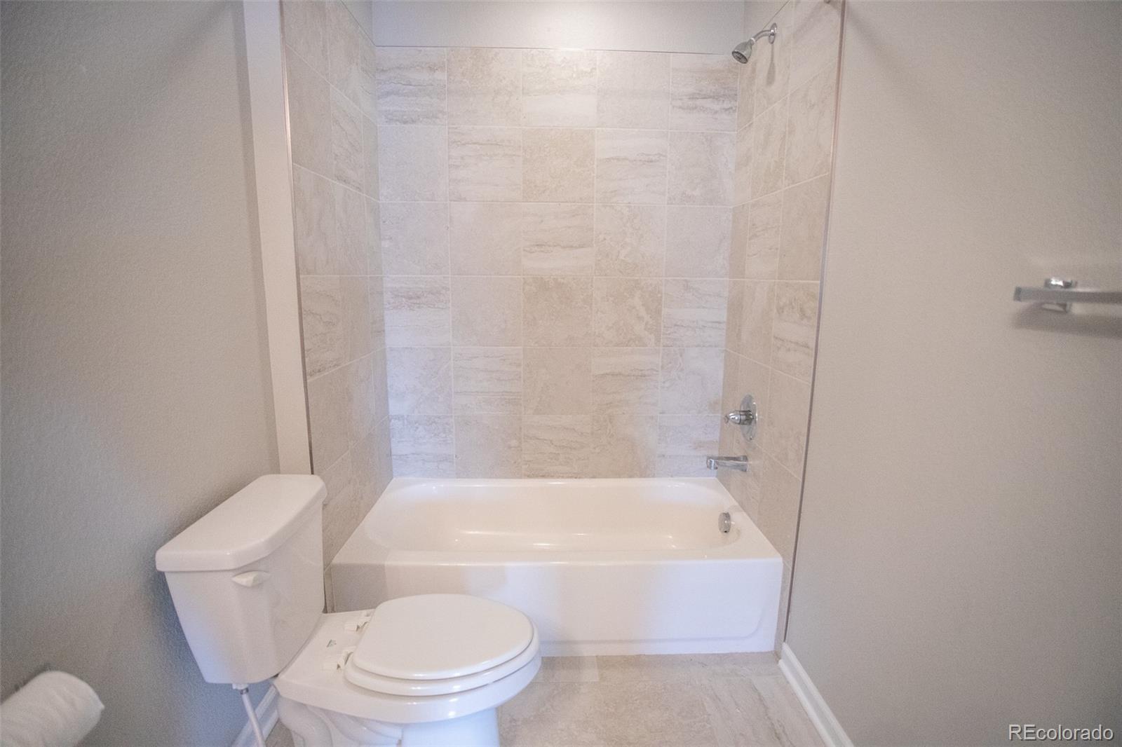16343 East 100th Way Commerce City, CO 80022 - Photo 23 of 38 a bathroom with a toilet and bathtub