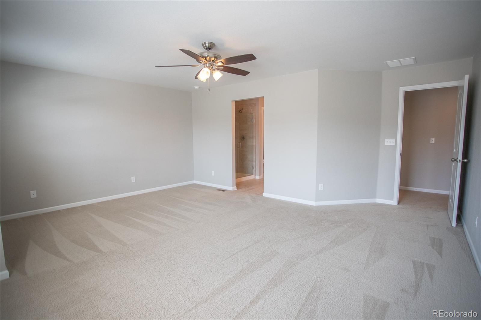 16343 East 100th Way Commerce City, CO 80022 - Photo 26 of 38 a view of an empty room with a fan