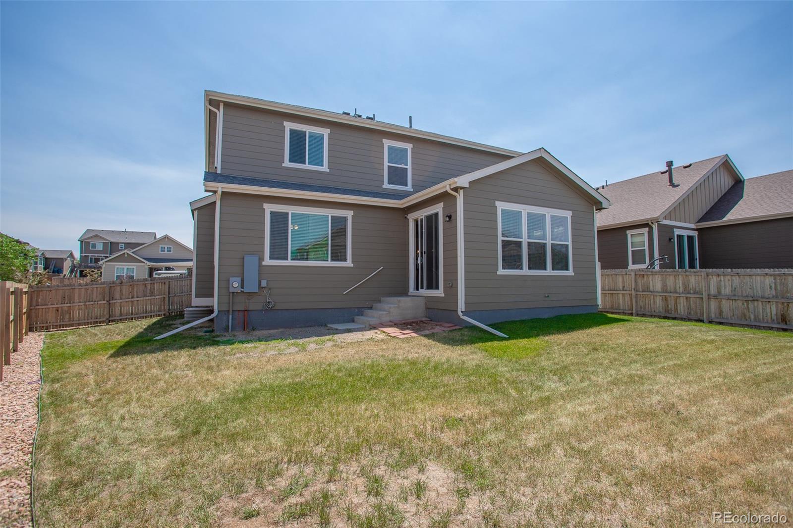 16343 East 100th Way Commerce City, CO 80022 - Photo 33 of 38 a house with yard in front of it