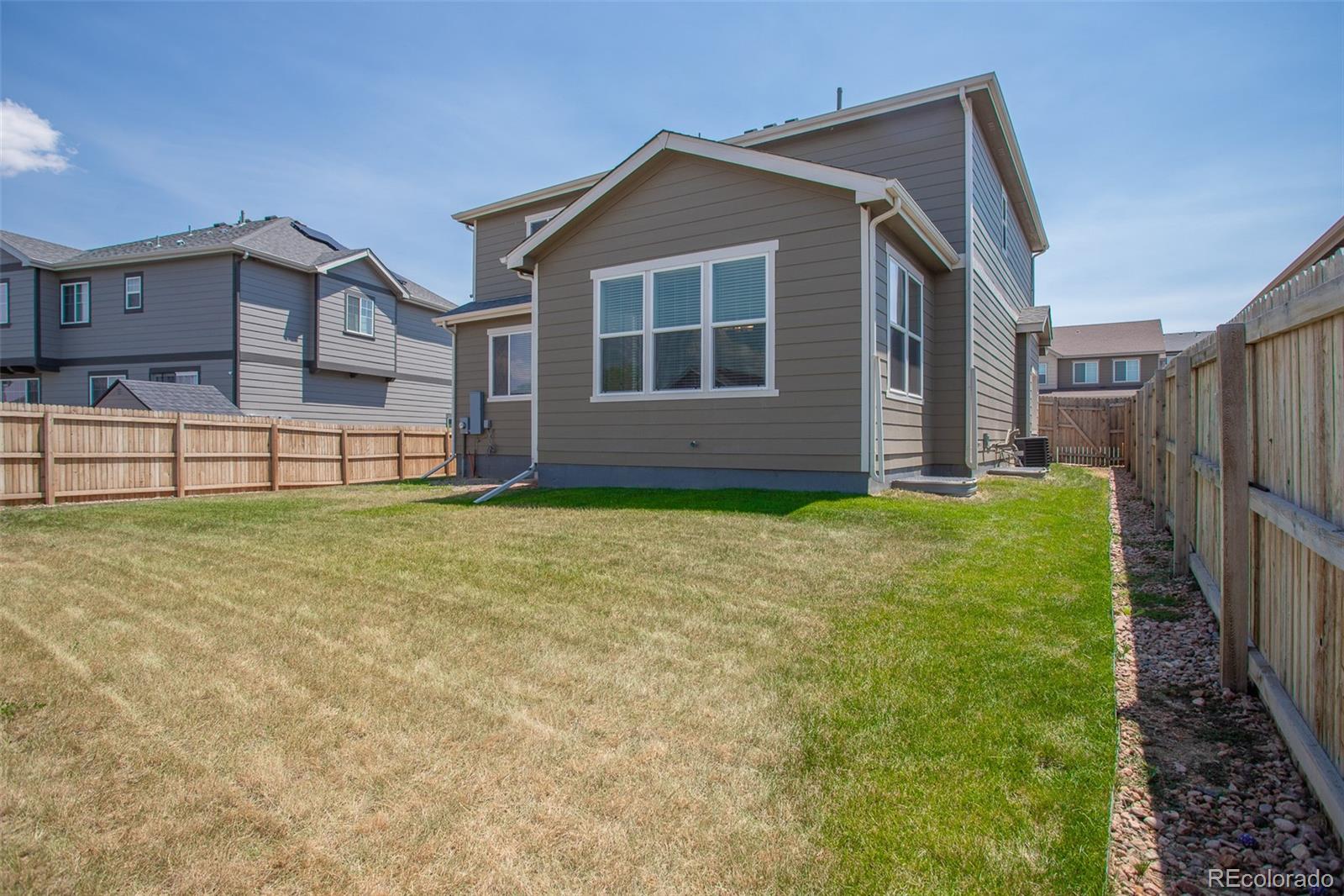16343 East 100th Way Commerce City, CO 80022 - Photo 34 of 38 a front view of a house with a yard