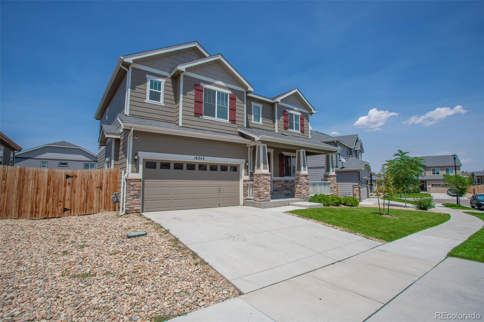 16343 East 100th Way Commerce City, CO 80022 - Photo 36 of 38 a front view of a house with a yard