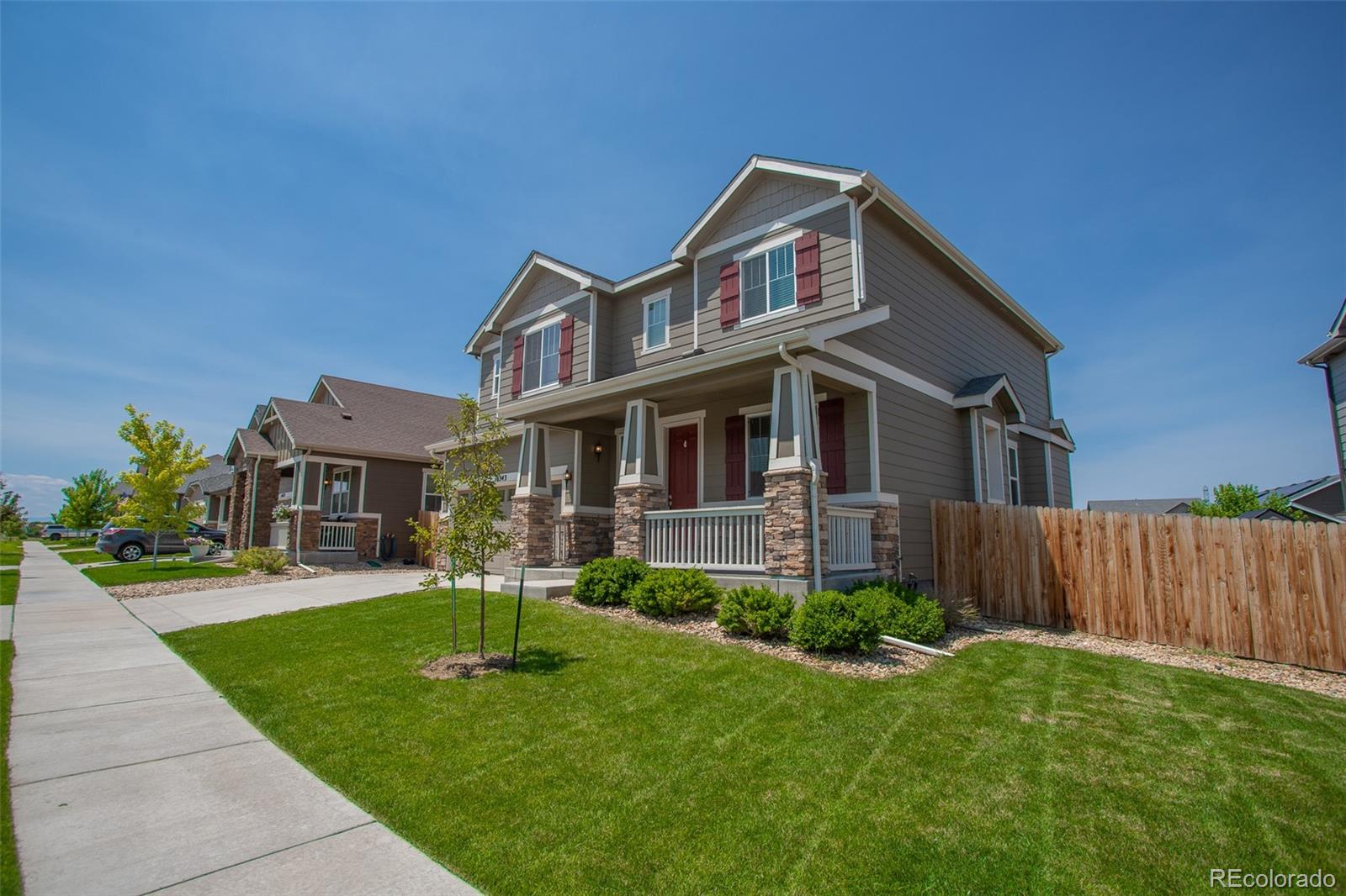 16343 East 100th Way Commerce City, CO 80022 - Photo 37 of 38 a front view of a house with a yard
