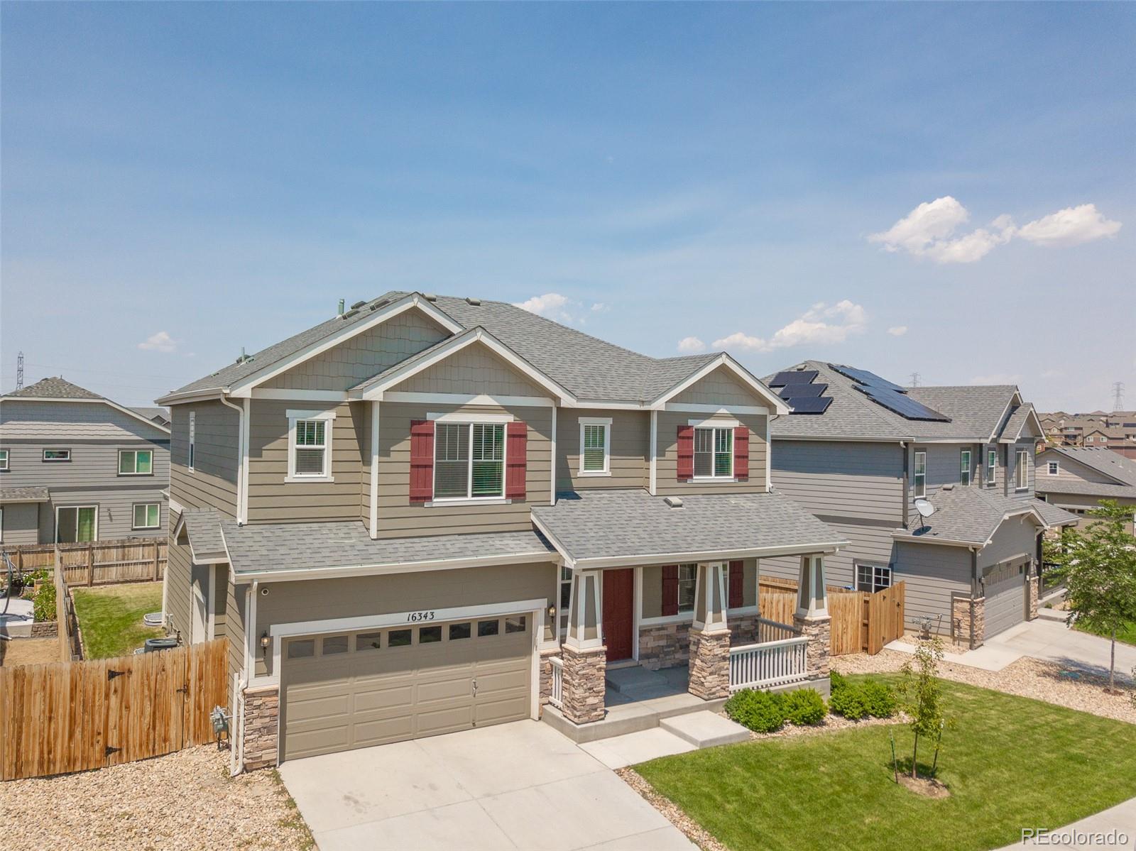16343 East 100th Way Commerce City, CO 80022 - Photo 38 of 38 a front view of a house with a yard