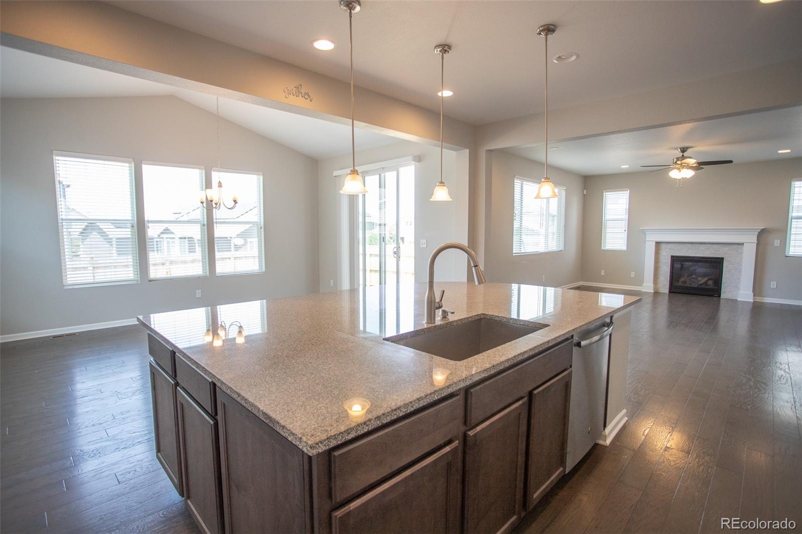 16343 East 100th Way Commerce City, CO 80022 - Photo 10 of 38 a kitchen with sink stove and cabinets
