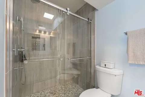 a bathroom with a glass shower door