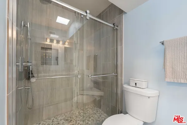 a bathroom with a glass shower door