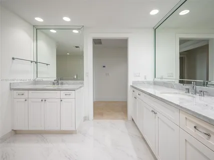 a spacious bathroom with a granite countertop sink a mirror and a
