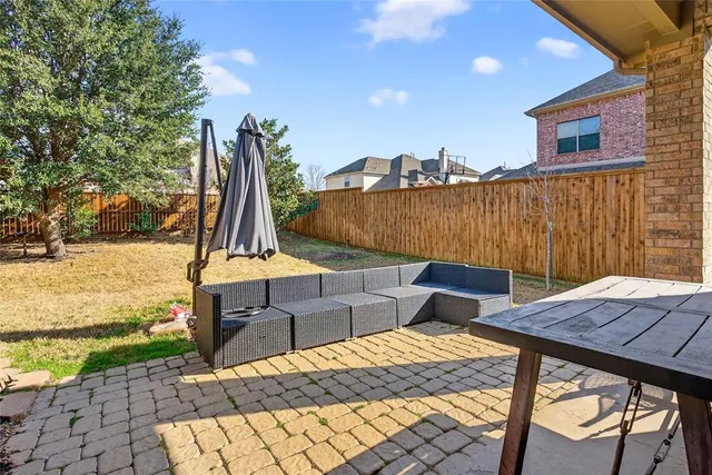 a front view of a house with a yard and potted plants