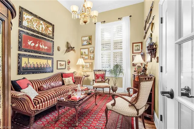 a living room with furniture and a chandelier